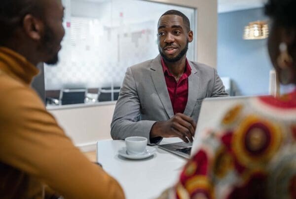 Financial Institution Insurance - Couple Meeting With a Financial Advisor and Bank Manager for Assistance at His Office in a Modern Building