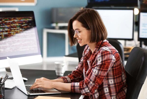 IT Contractor Insurance - Young Female Programmer Working in a Modern Office for Tech Support and Software Development