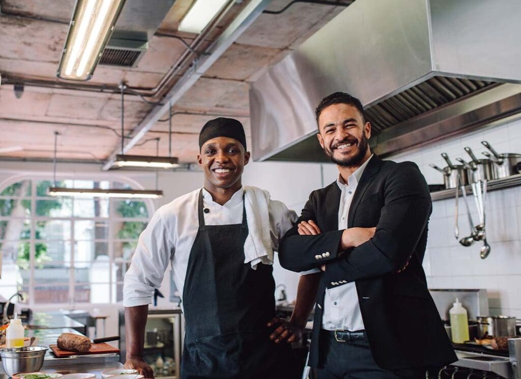 Insurance - Portrait of a Happy Restaurant Owner and Chef in the Kitchen of a Brand New Establishment