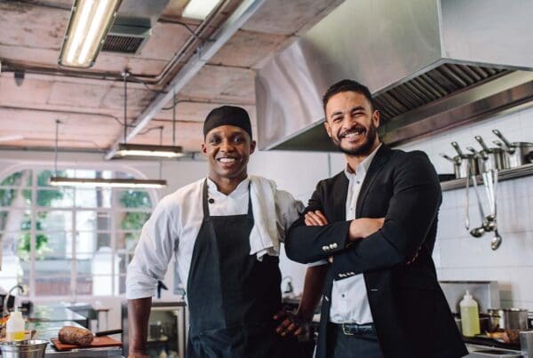 Insurance - Portrait of a Happy Restaurant Owner and Chef in the Kitchen of a Brand New Establishment